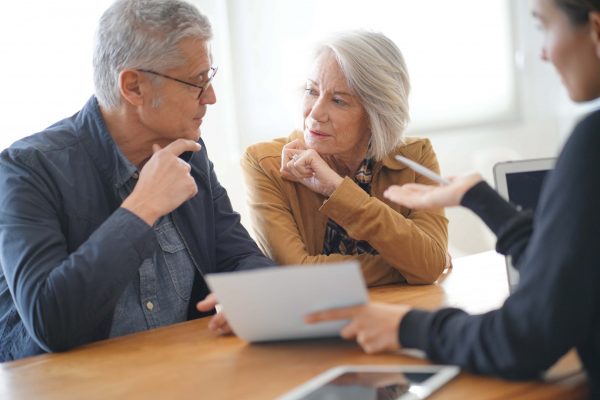 Modern senior couple signing housing contract