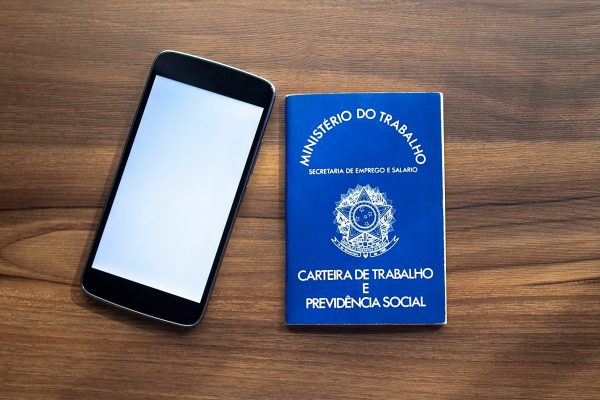 Brazilian document work and social security ( Carteira de Trabalho e Previdencia Social) with smartphone